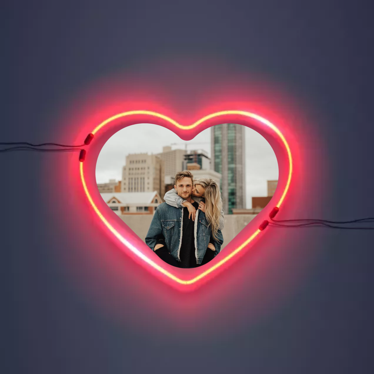 A Man And A Woman Standing In Front Of A Neon Heart Template
