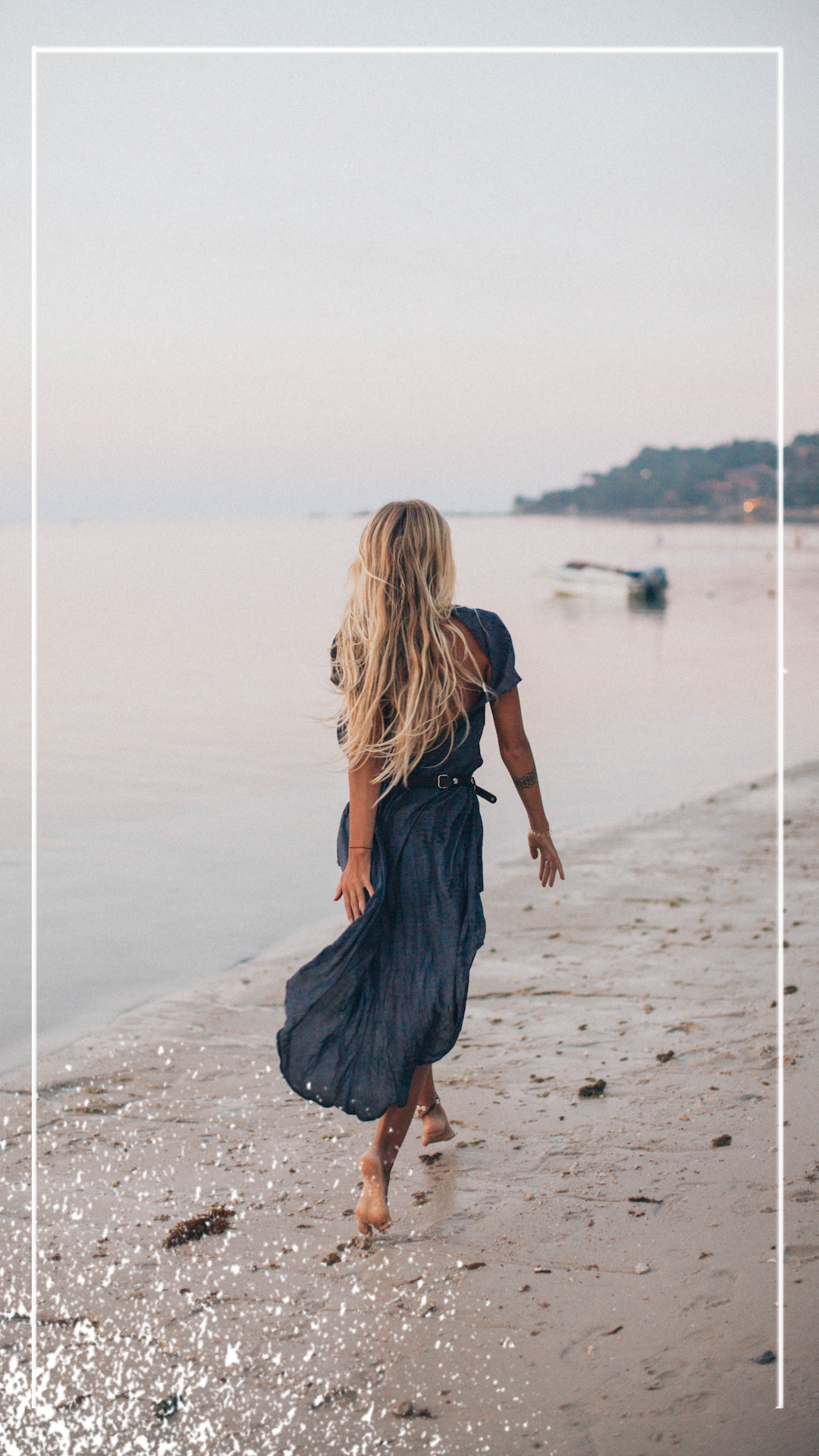 A Woman Walking Along A Beach Next To The Ocean Classy Template