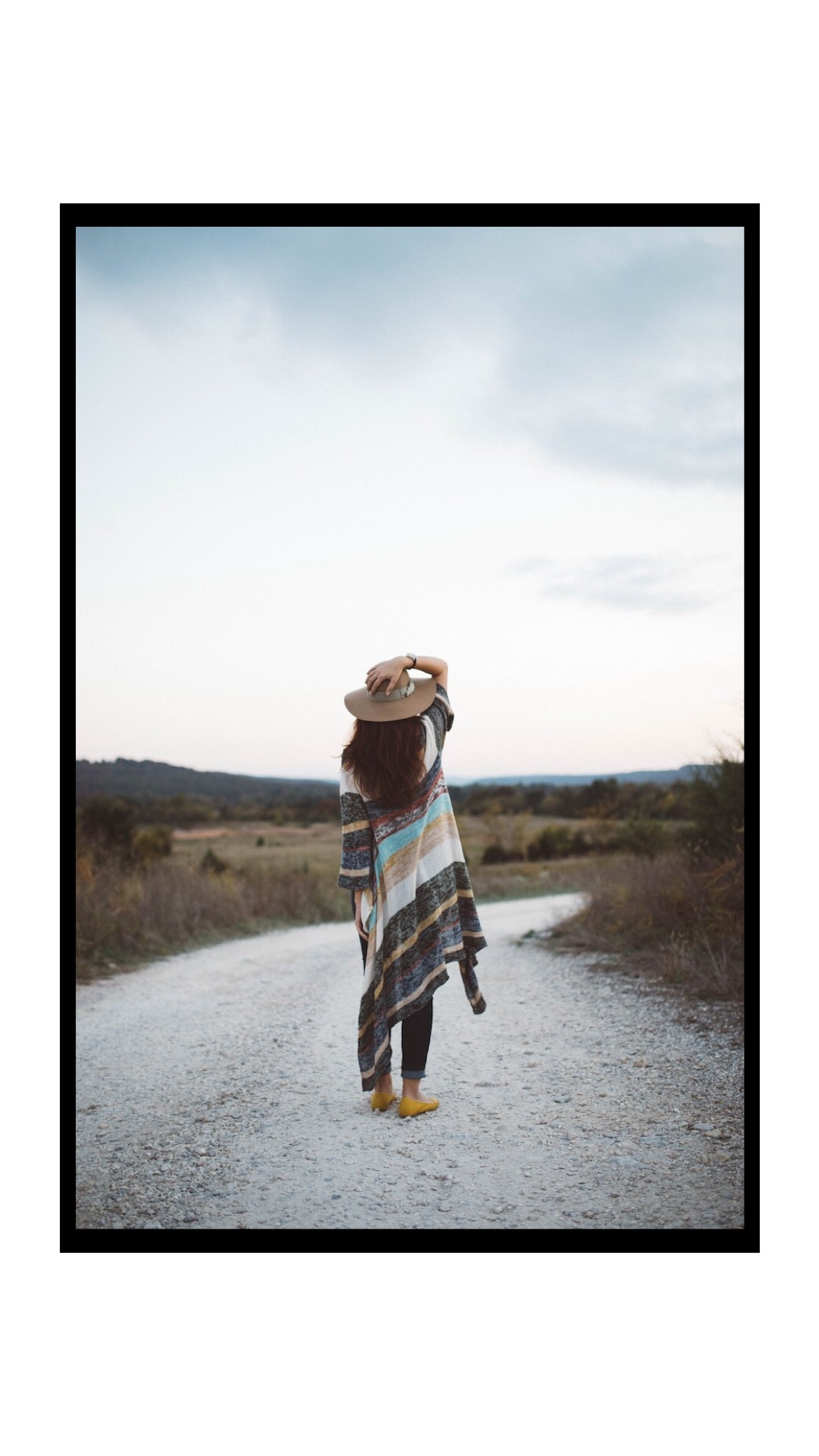 A Woman Walking Down A Dirt Road With A Hat On Classy Template